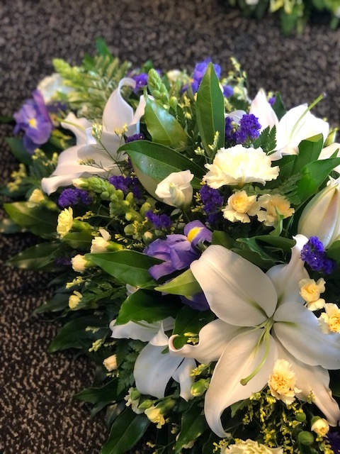 Blue, Yellow and White Casket Spray