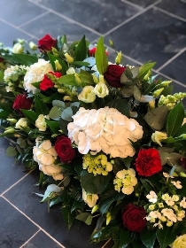 Mixed Casket Spray Red Green and White